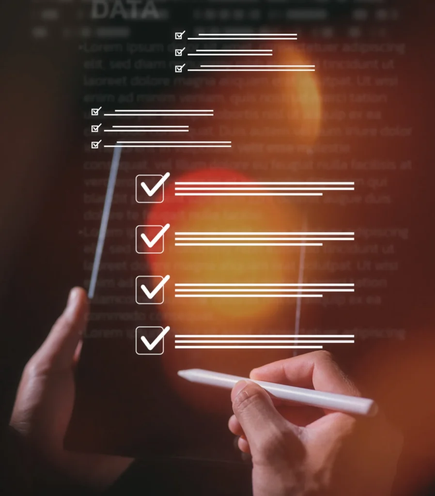 Hands using a stylus to check items off a digital inventory checklist display
